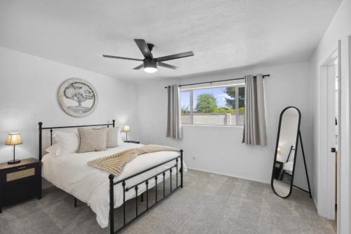 a bedroom with a bed and a ceiling fan at Boho on Bermuda By Rather Be Properties in Tucson