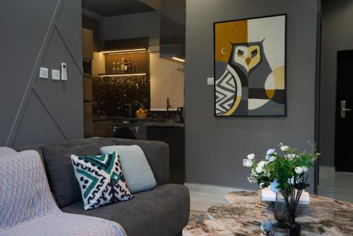 a living room with a couch and a table at Dark Apartment in Lekki in Lagos