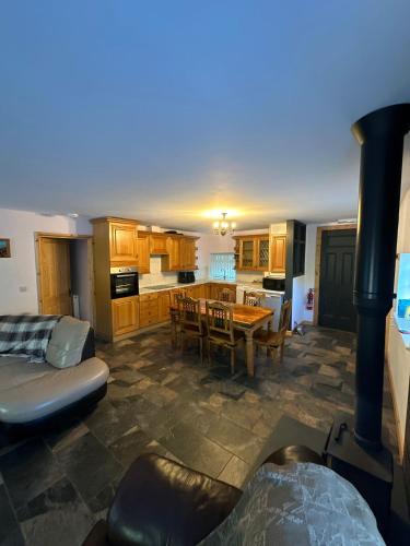 a kitchen and dining room with a table and a stove at The Falcon Inn Retreat in Aberdare