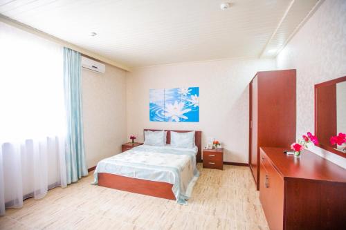 a bedroom with a bed and a large window at Bliss Inn Hotel Gabala Vandam in Gabala