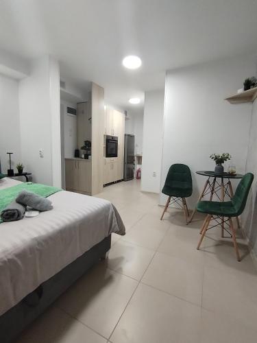 a bedroom with a bed and a table and chairs at Studio Jovana Stan na dan Kikinda in Kikinda