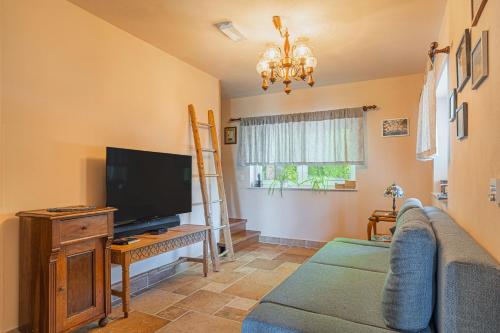a living room with a couch and a flat screen tv at Homestead Kunigunda in Celje