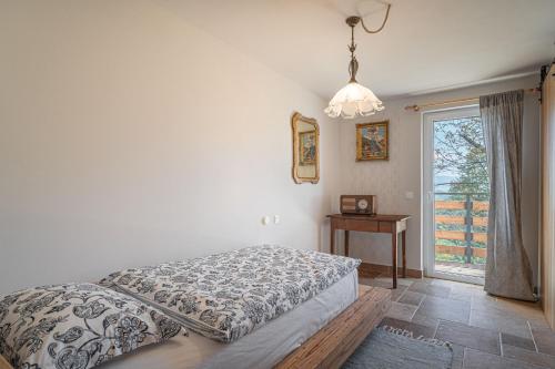 a bedroom with a bed and a window and a table at Homestead Kunigunda in Celje