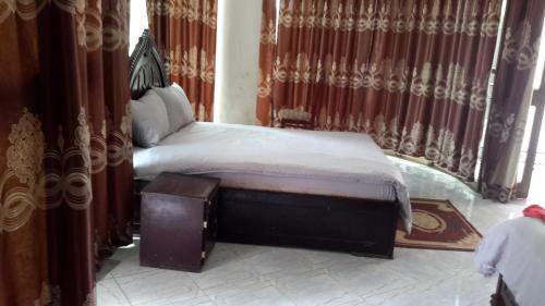 a bed in a room with curtains and a bed sidx sidx sidx at DV Guest House in Addis Ababa