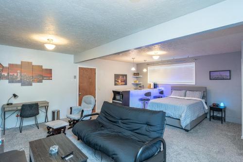 a living room with a bed and a couch at Tranquil Private Studio in Lacey