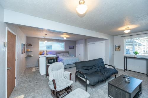 a living room with a couch and a bed at Tranquil Private Studio in Lacey