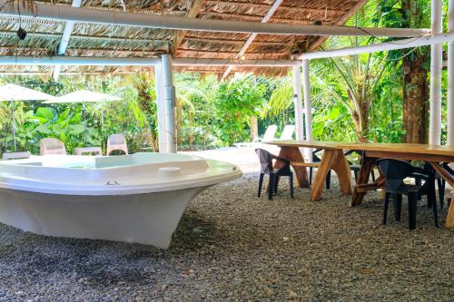 a bath tub sitting in a room with a table at Bambutel Cocles in Puerto Viejo