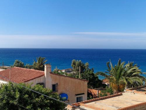 a view of the ocean from a building at Duplex trouville à 2 pas de la plage in 'Aïn el Turk