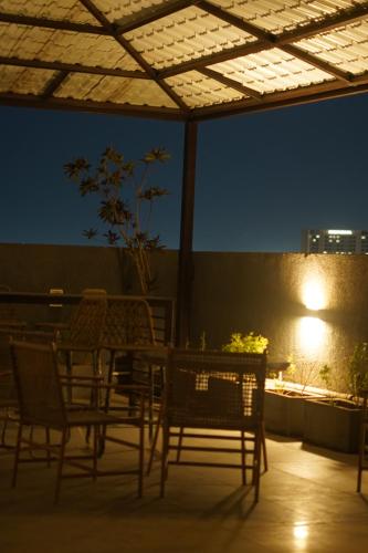 a table and chairs on a patio at night at The Nest Studio by Raaya Nook in Jaipur