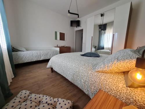 a bedroom with two twin beds and a lamp at La Chicca di Milu' for Pet Lovers in Alcamo