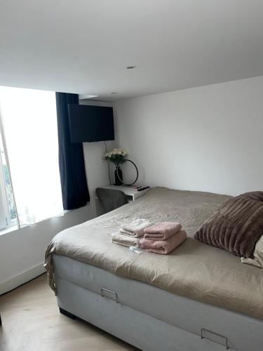 a bedroom with a bed with two towels on it at WaalPlaat's B&B in Amsterdam