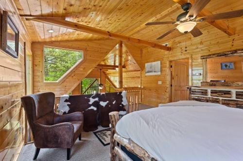 a bedroom with a bed and a ceiling fan at Gentle Ben's Chalet in Murphy