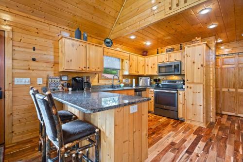 a kitchen with a large island in a wooden cabin at Gentle Ben's Chalet in Murphy