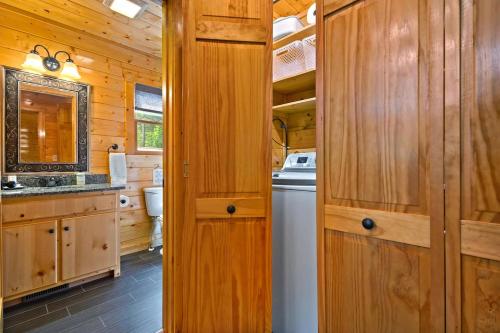 a kitchen with wooden cabinets and a washer and dryer at Gentle Ben's Chalet in Murphy