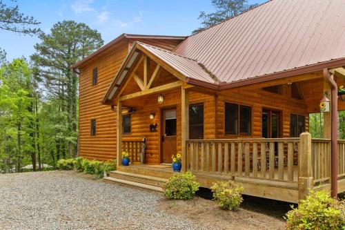 a log cabin with a porch and a roof at Gentle Ben's Chalet in Murphy