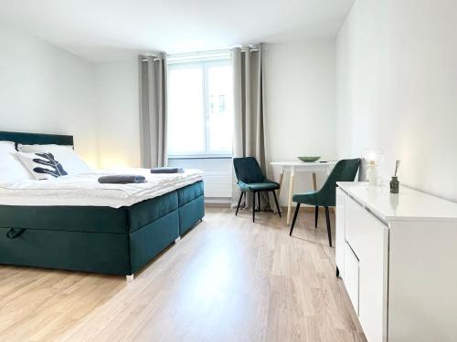 a bedroom with a bed and a table and chairs at Central city apartment in Zurich! in Zürich