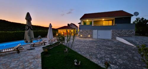 a house with a swimming pool in front of it at Villa Ana with a private pool on a 3000m2 property in Čvrljevo