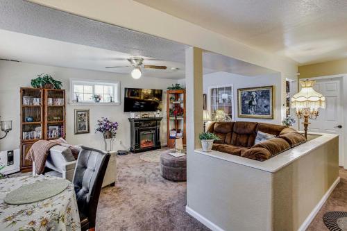 a living room with a couch and a table at Lower-Level Apt with Hot Tub and Sauna in Graham! in Graham