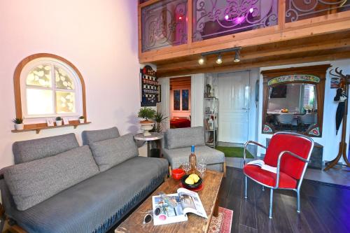 a living room with a couch and a red chair at DUPLEX 5 chambres Clim WIFI SAUNA Cannes in Cannes