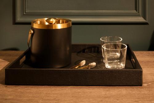 a black tray with a drink and a glass on a table at OS Hotel in Ocean Springs