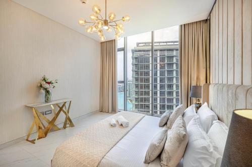 a bedroom with a bed and a large window at Luxury 2 Bedroom plus kids room Burj Khalifa View in Dubai