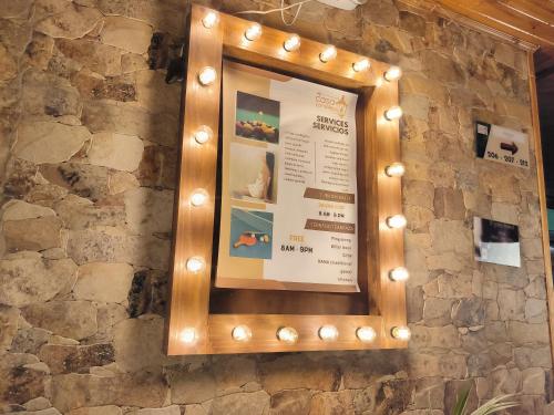 a framed sign on a stone wall with lights at Casa Candilejas in Bogotá