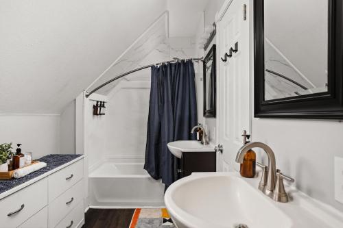 a bathroom with two sinks and a bath tub at 4BD near Indy 500 Speedway - BBQ & Backyard in Indianapolis