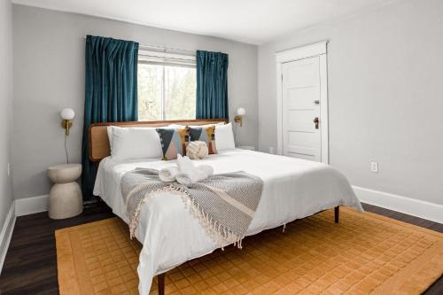 a bedroom with a large white bed with blue curtains at 4BD near Indy 500 Speedway - BBQ & Backyard in Indianapolis