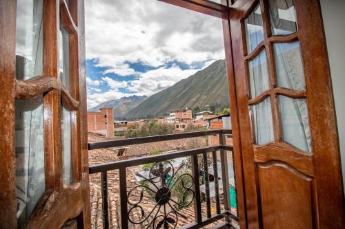 an open door to a balcony with a view at Valle Del Sol in Urubamba