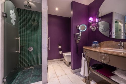 a purple bathroom with a shower and a sink at Selectum Luxury Resort Belek in Belek