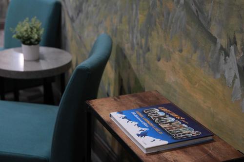 a book sitting on a table next to a blue chair at Boulder Twin Lakes Inn in Boulder