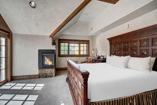 a bedroom with a large bed and a fireplace at Lodge at Vail, A RockResort in Vail