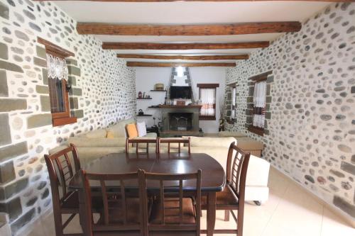 a kitchen and dining room with a table and chairs at Guest House Mehmeti in Tolar