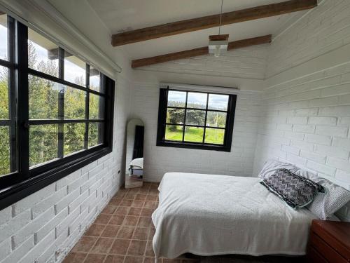 Postel nebo postele na pokoji v ubytování Casa de campo en Ibarra