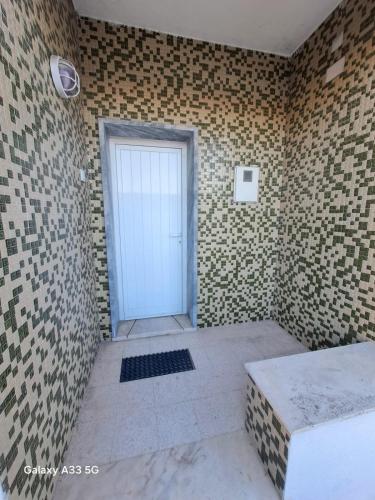a room with a door in a brick wall at HOSTEL MISTO-Low Cost Palmela in Palmela