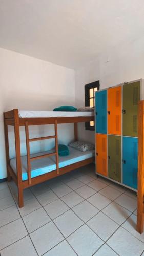 a room with two bunk beds and a cabinet at Hostel ABC in Angra dos Reis
