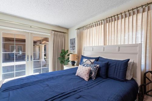 a bedroom with a large bed with blue pillows at Home in San Diego! The Blue Leaf with 3bed 2bath, Golf, Large Yard! in Rancho Bernardo