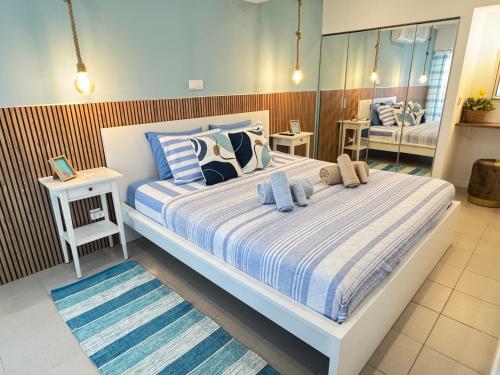 a bedroom with a large bed with blue and white sheets at SummerHouse - Holiday place! in Portimão