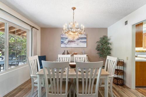 a dining room with a table and chairs and a chandelier at Home in San Diego! The Blue Leaf with 3bed 2bath, Golf, Large Yard! in Rancho Bernardo