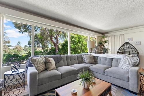 a living room with a couch and a large window at Home in San Diego! The Blue Leaf with 3bed 2bath, Golf, Large Yard! in Rancho Bernardo