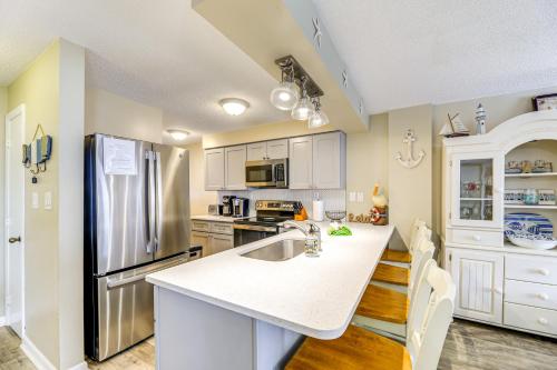 a kitchen with a sink and a refrigerator at Walk to Indian Beach Condo with Ocean-View Balcony in Indian Beach