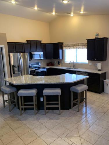 a kitchen with a large island with bar stools at Mesquite paradise in Mesquite