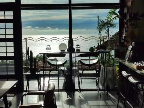 a room with a table and a view of the ocean at 濱境行旅 Begin Inn in Xiaoliuqiu