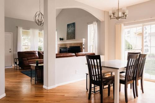 a kitchen and dining room with a table and chairs at Cozy Retreat - King Beds - Cinema Cave & Home Gym in Westminster