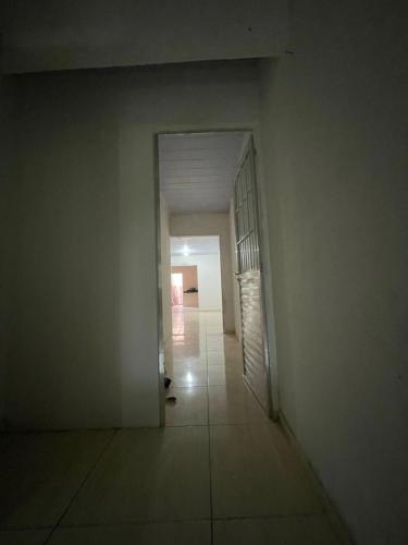 an empty hallway with a cat sitting in the doorway at Apartamento Avenida Caruaru in Garanhuns