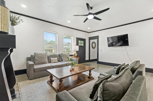 a living room with a couch and a table at 6BR Home 10 mins Devon Park, Sleeps 16 #15 in Oklahoma City