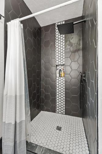 a bathroom with a shower with a shower curtain at 6BR Home 10 mins Devon Park, Sleeps 16 #15 in Oklahoma City