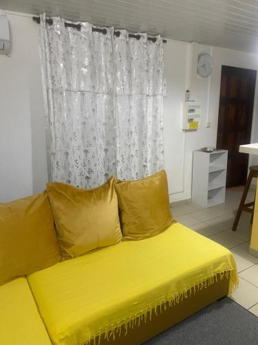 a yellow couch with yellow pillows in a room at Bella in Galmot