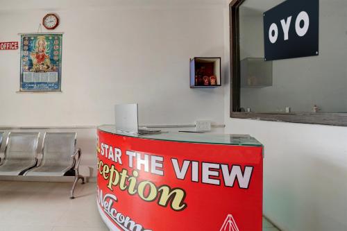 a reception desk in a waiting room with a mirror at Hotel O Star The View in Kānpur