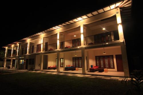 a lit up building at night with lights on it at JJ's Hostel Mirissa in Mirissa